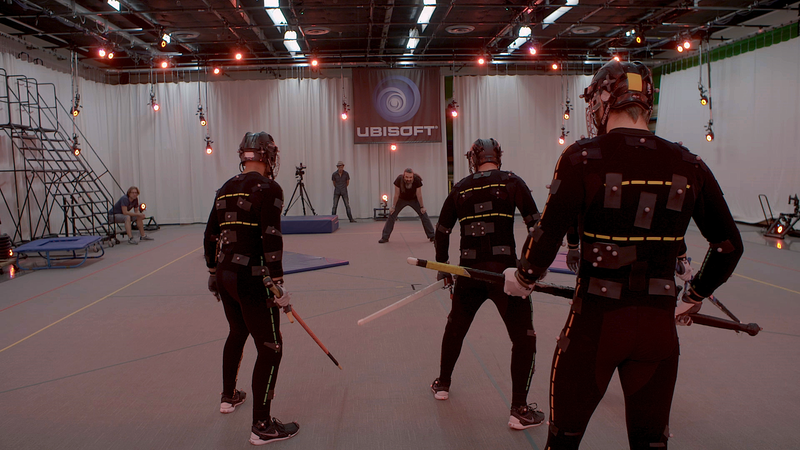 Actors in motion capture suits performing moves that would later be animated into the game.